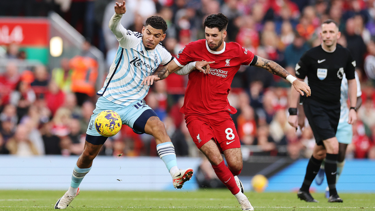 LIVERPOOL, ENGLAND - OCTOBER 29: Morgan Gibbs-White of Nottingham Forest is challenged by Dominik Szoboszlai of Liverpool during the Premier League match between Liverpool FC and Nottingham Forest at Anfield on October 29, 2023 in Liverpool, England. (Photo by Jan Kruger/Getty Images)