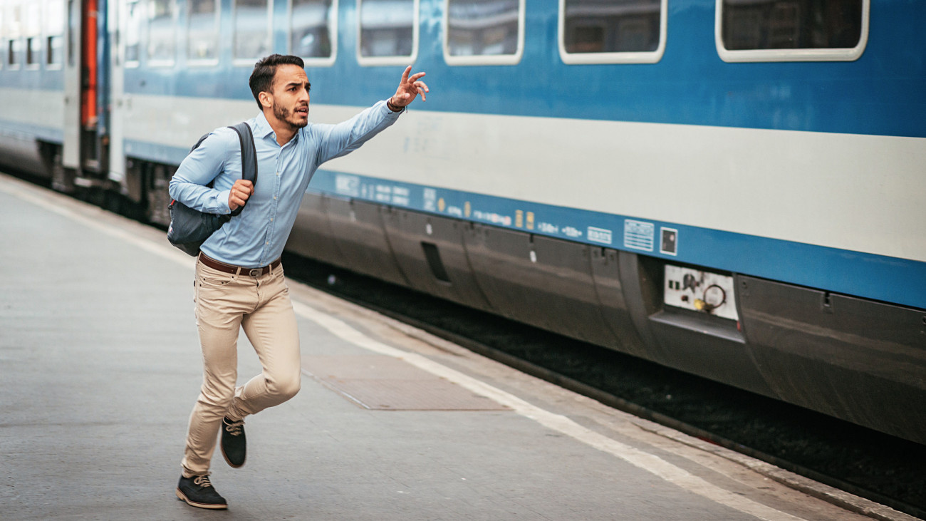 Portrait of Latin American young man in smart casual clothing, representing young businessman, entrepreneur or University student. Handsome Latino in blue shirt commuting to work, having coffee break or communicating with business partners.