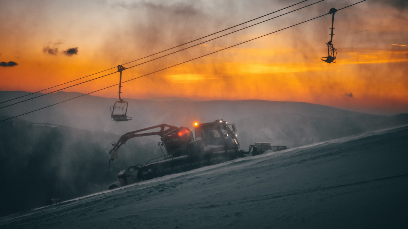 DONOVALY, SLOVAKIA, 5. JANUARY, 2017: Ski tractor in ski resort, sunset light in background