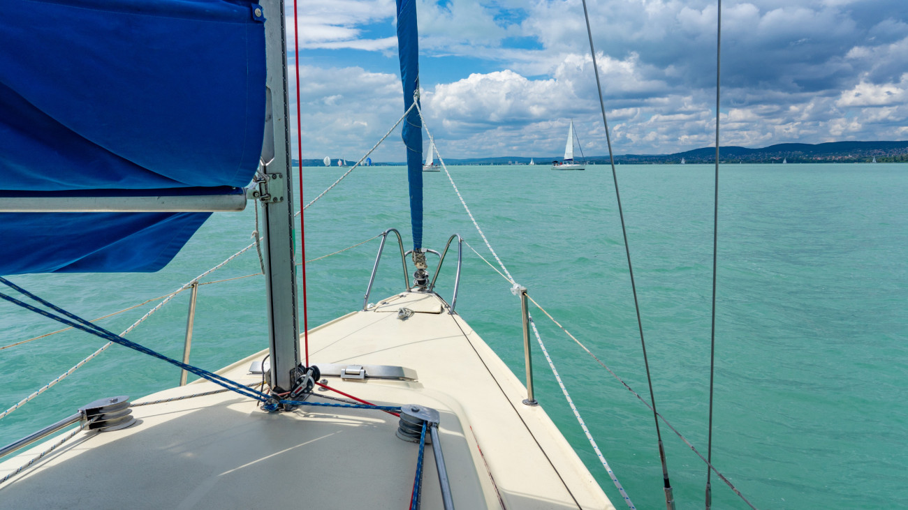 Sailboat on the lake Balaton ship prow view and other sailboats in the background .