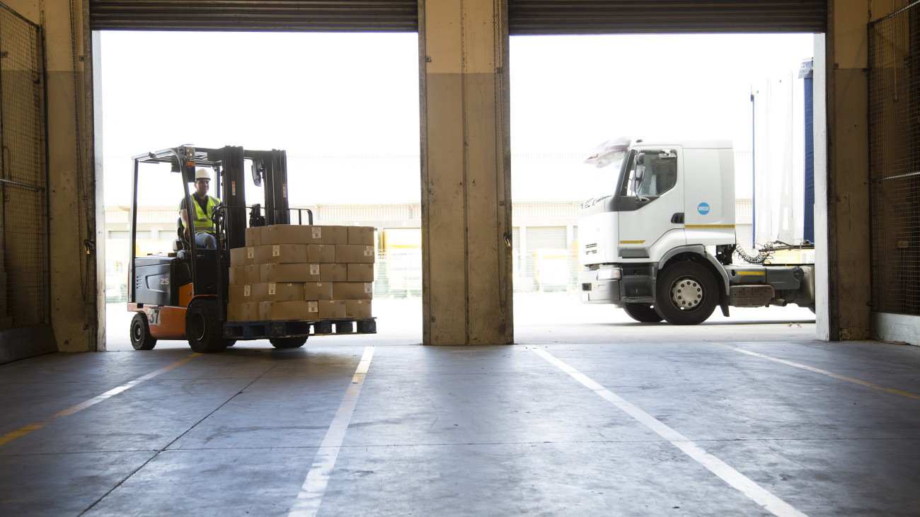 Forklift truck unloading a lorry into a food distribution warehouse