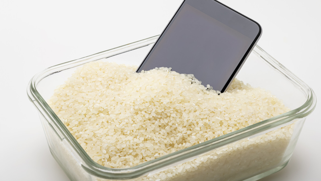 A wet smartphone is dried in japanese rice on glass box with , Can be used as a background