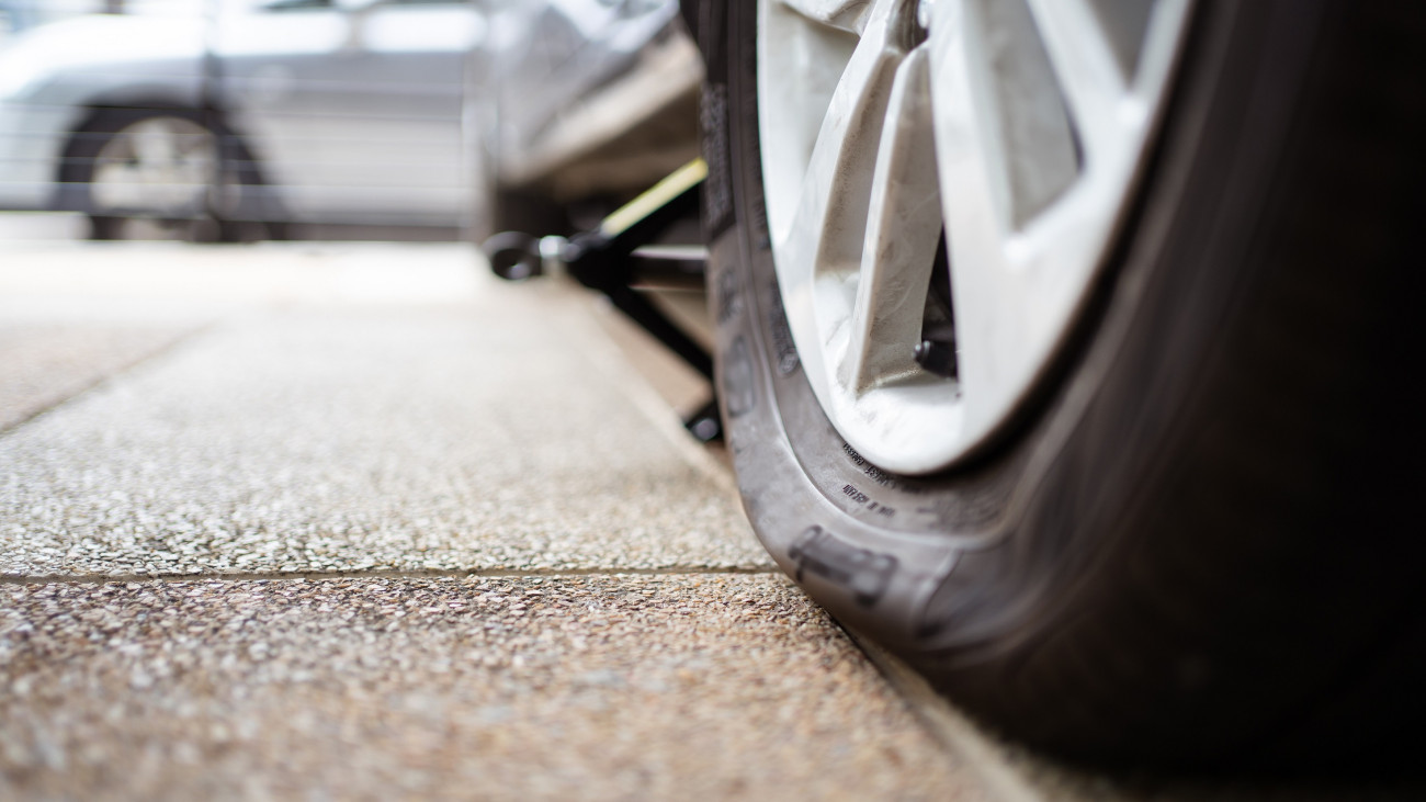 Close up photograph of damaged wheel - flat tire of an accident vehicle. A car have an accident on a wheel.