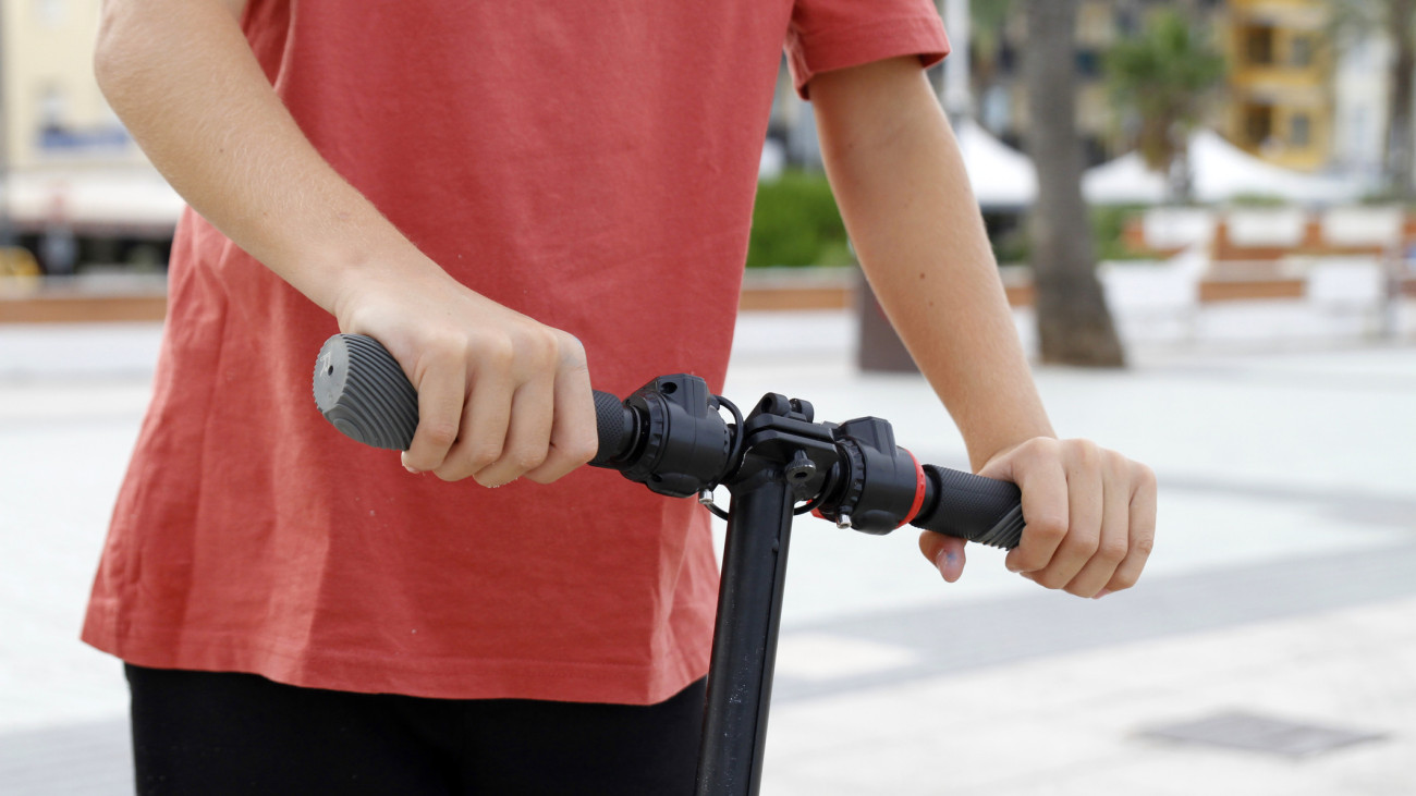Hands on handlebar of scooter, close-up