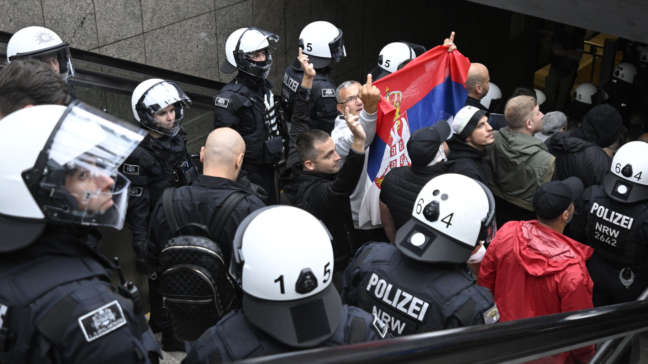 GELSENKIRCHEN, GERMANY - JUNE 16: Riot police escort Serbia fans at Hauptbahnhof main railway station prior to the Group C England v Serbia match of the UEFA EURO 2024 football championship on June 16, 2024 in Gelsenkirchen, Germany. Serbia and England fans clashed in the city center at several locations. (Photo by Sascha Schuermann/Getty Images)