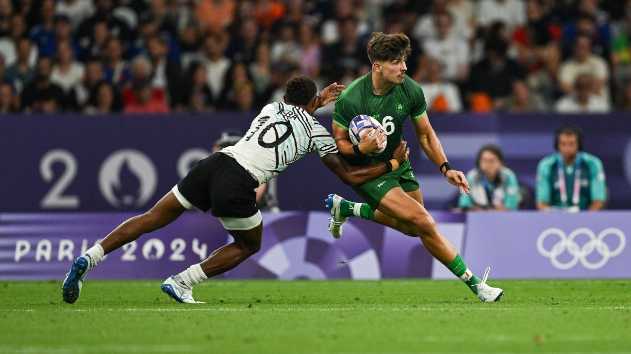 Paris , France - 25 July 2024; Chay Mullins of Team Ireland is tackled by Iowane Teba of Team Fiji during the Mens Rugby Sevens Quarter-Final  match between Team Fiji and Team Ireland at the Stade de France during the 2024 Paris Summer Olympic Games in Paris, France. (Photo By Brendan Moran/Sportsfile via Getty Images)