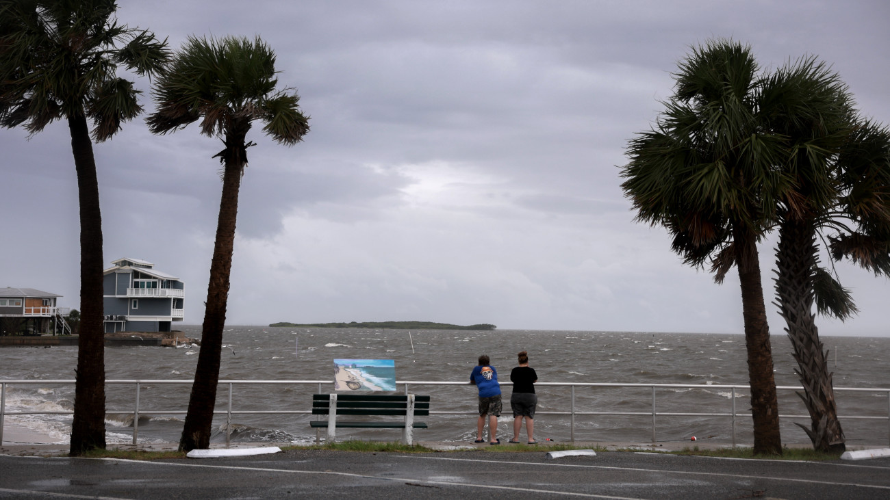 CEDAR KEY, FLORIDA - AUGUST 04: People look out at the gathering storm before the possible arrival of Tropical Storm Debby, which is strengthening as it moves through the Gulf of Mexico on August 04, 2024 in Cedar Key, Florida. Forecasters say Tropical Storm Debby could become a hurricane as soon as Sunday evening, bringing rain storms and high winds along Floridaâs west coast. (Photo by Joe Raedle/Getty Images)
