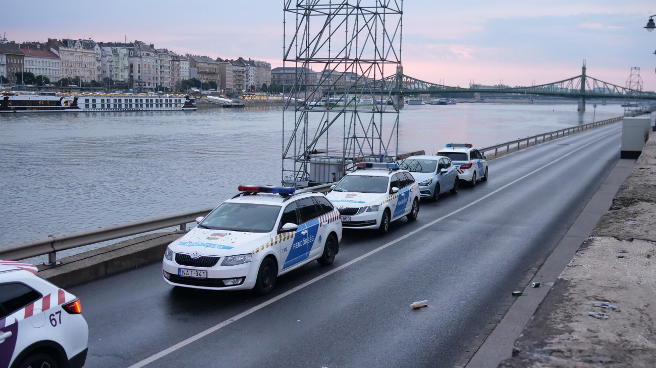 Rendőrautók a budai alsó rakparton 2024. augusztus 15-én. Zenés rendezvényt tartottak az Ördög-árok dunai torkolatánál, ahonnan a hirtelen kizúduló csapadékvíz több embert sodort a folyóba. A Budapesti Rendőr-főkapitányság közlése szerint bár a helyszínen meghallgatott mintegy 30 tanú nem jelezte, hogy bárki eltűnt volna, a vízirendészet hajói folytatják a folyószakasz átfésülését.