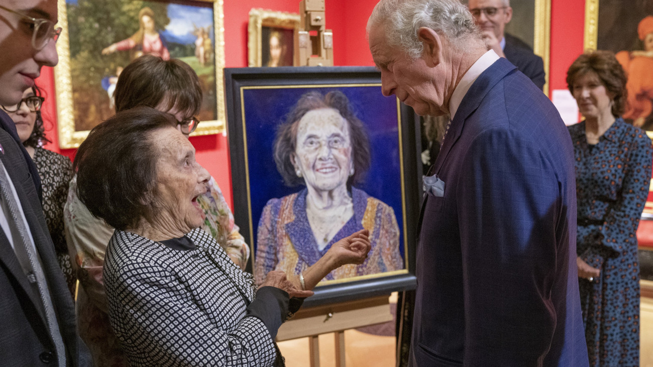 LONDON, ENGLAND - JANUARY 24:  Prince Charles, Prince of Wales speaks with with survivor Lily Ebert at an exhibition of Seven Portraits: Surviving the Holocaust, which were commissioned by Prince Charles, Prince of Wales to pay tribute to Holocaust survivors, at The Queens Gallery, Buckingham Palace on January 24, 2022 in London, England. (Photo by Arthur Edwards - WPA Pool/Getty Images)