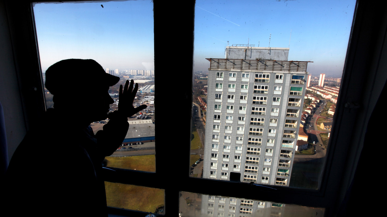 GLASGOW, SCOTLAND - MARCH 08:  An asylum seeker looks from his window onto the high rise flats where a woman and two men fell to their death  March 8, 2010 in Glasgow, Scotland. Police are continuing an investigation into the apparent triple suicide, which happened on Sunday morning, at the Red Road flats in Springburn.  (Photo by Jeff J Mitchell/Getty Images)