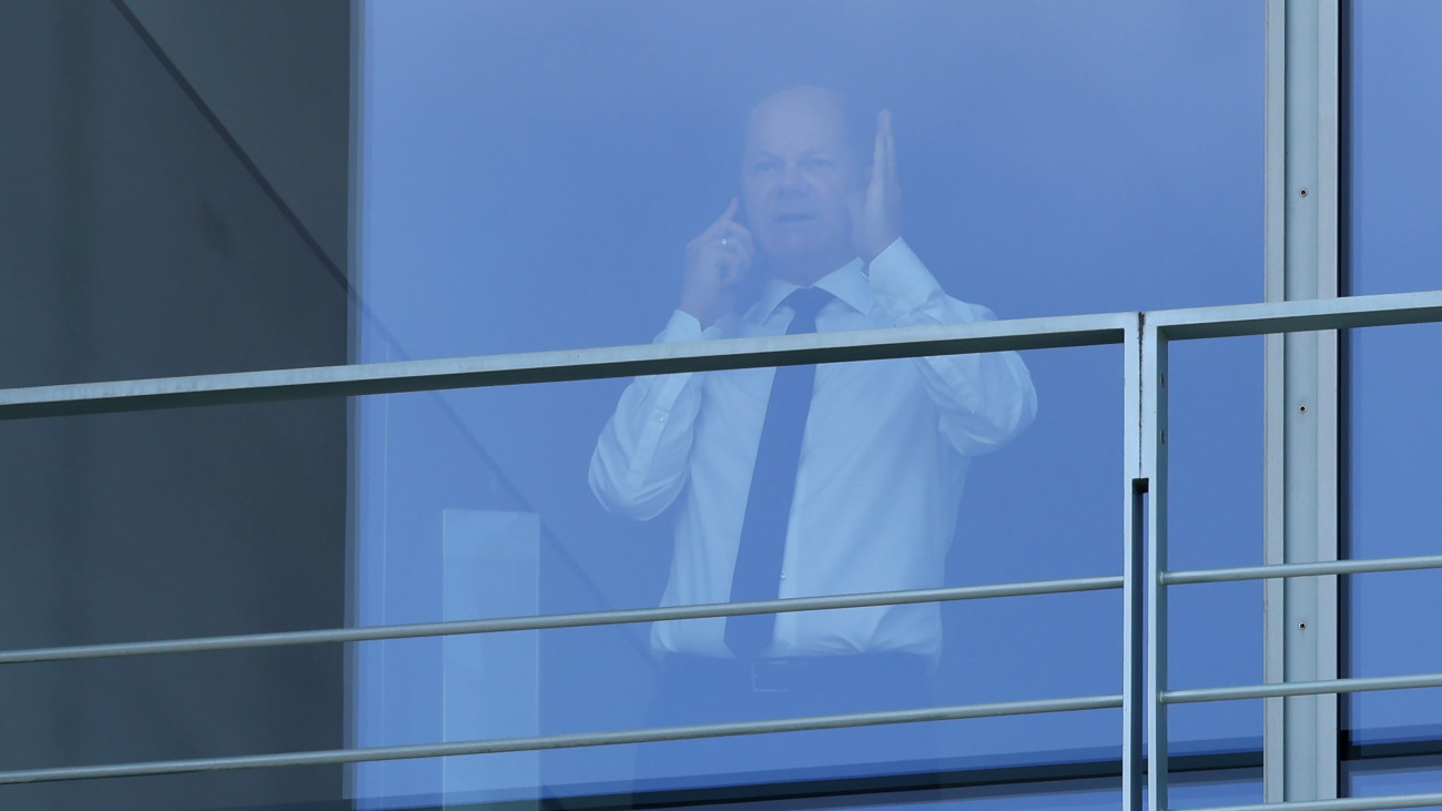 BERLIN, GERMANY - SEPTEMBER 12: German Chancellor Olaf Scholz stands at a window in his office as he speaks on a mobile phone prior to the arrival of interim Israeli Prime Minister Yair Lapid at the Chancellery on September 12, 2022 in Berlin, Germany. The two leaders discussed common issues related to energy, security and a possible sale of an Israeli anti-missile system to Germany. (Photo by Sean Gallup/Getty Images)