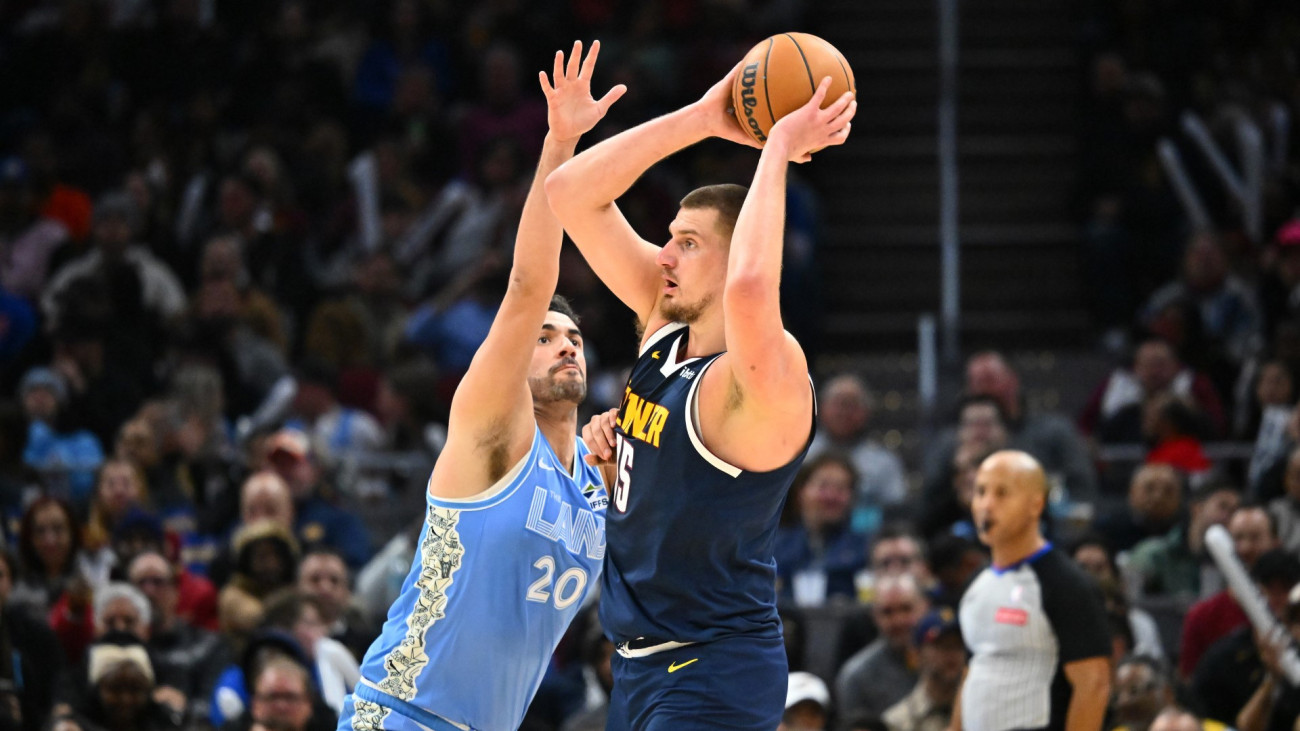 Georges Niang #20 of the Cleveland Cavaliers guards Nikola Jokic #15 of the Denver Nuggets during the first half at Rocket Mortgage Fieldhouse on December 05, 2024 in Cleveland, Ohio. The Cavaliers defeated the Nuggets 126-114. NOTE TO USER: User expressly acknowledges and agrees that, by downloading and or using this photograph, User is consenting to the terms and conditions of the Getty Images License Agreement.