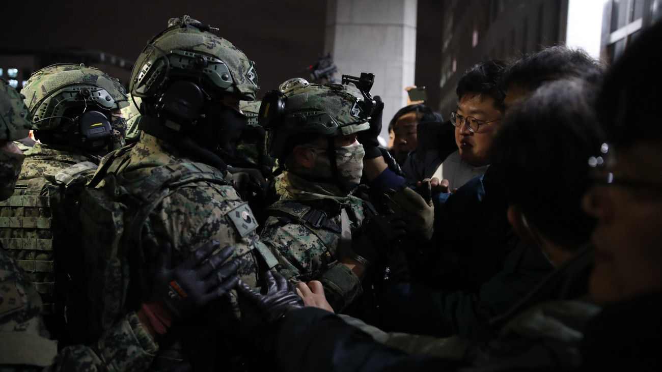 SEOUL, SOUTH KOREA - DECEMBER 04: South Korean soldiers try get into the national assembly on December 04, 2024 in Seoul, South Korea. Yoon Suk Yeol announced he was taking the step, which enacts temporary rule by the military, during a televised speech on Tuesday, saying it was critical for defending the countrys constitutional order. Since taking office two years ago, Mr Yoon has struggled to push his agendas against an opposition-controlled parliament.