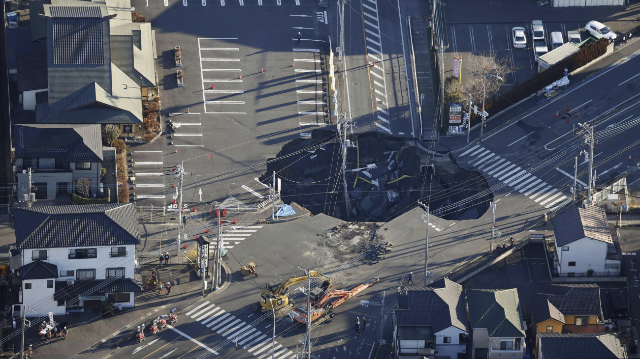 Légi felvételen mentőalakulatok tagjai dolgoznak egy víznyelőbe szorult teherautó sofőrjének a kimentésén a Szaitama prefektúrában fekvő Jasióban 2025. január 30-án. A mentőalakulatok két napja dolgoznak a teherautó 74 éves sofőrjének kimentésén, ugyanis a jármű kabinja a víznyelőbe szorult, az autó többi részét viszont sikerült kiemelni.