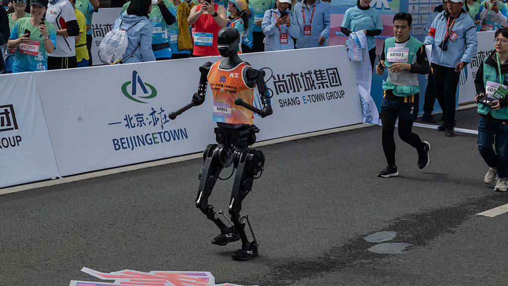 BEIJING, CHINA - APRIL 19: A Humanoid robot called Tiangong runs after the finish line in the Beijing E-Town Humanoid Robot Half Marathon on April 19, 2025 in Beijing, China. According to organizers, the event was the first of its kind and featured twenty-one humanoid robot runners.  (Photo by Kevin Frayer/Getty Images)