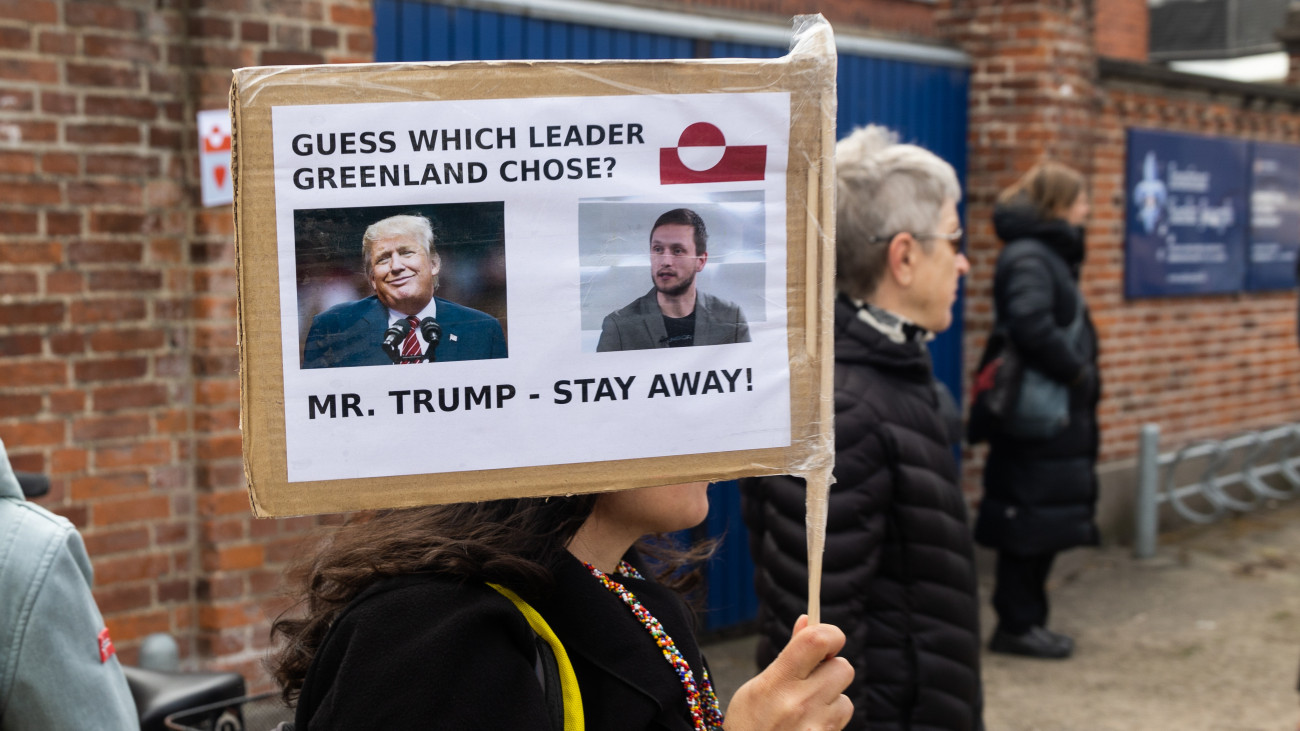 COPENHAGEN, DENMARK - 2025/04/06: A protester holds a placard with a photo of United States President Donald Trump and Greenlands newly elected head of government, Jens-Frederik Nielsen during a demonstration against the Trump administration. Protesters gathered in front of the American Embassy in response to the Trump administrations repeated statements about wanting control over Greenland. These statements, which questioned Denmarks sovereignty and emphasized Greenlands strategic value, sparked outrage in both Greenland and Denmark. Greenlandic leaders and citizens strongly rejected any suggestion of being for sale, stressing their right to self-determination and fears of losing their cultural identity. The situation has unified Greenlands political parties and raised broader concerns about international law and Arctic geopolitics. (Photo by Kristian Tuxen Ladegaard Berg/SOPA Images/LightRocket via Getty Images)