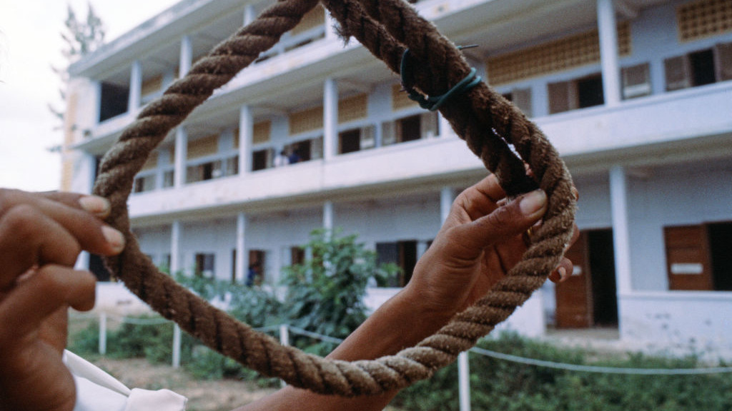 Death of a nation: an incredible human disaster has happened in Cambodia, where an estimated two million people have been killed by a fanatical regime whose apparent aim was to wipe out anyone and everything connected with the modern world. The evidence of this appalling massacre is only now coming to light after almost four years of torture, starvation and mass murder on a gigantic scale. Pictured, death drop, the Khmer Rouge strung their victims up by the feet and then dropped them on their heads. September 1979. (Photo by Eric Piper/Mirrorpix/Getty Images)