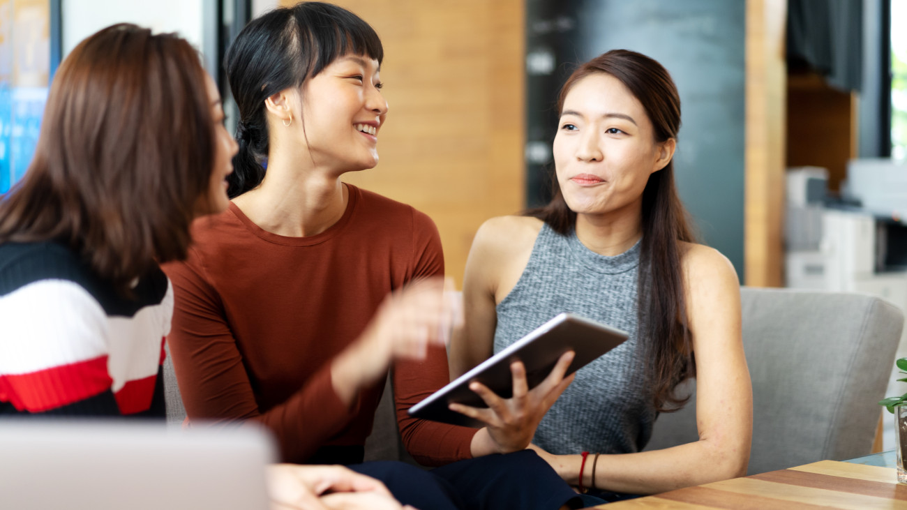 chinese girls talking with digital tablet