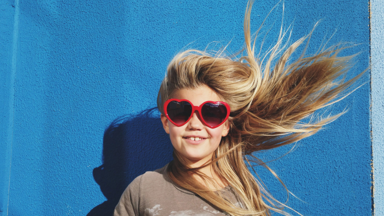 Portrait of a young girl with hair blowing in strong winds