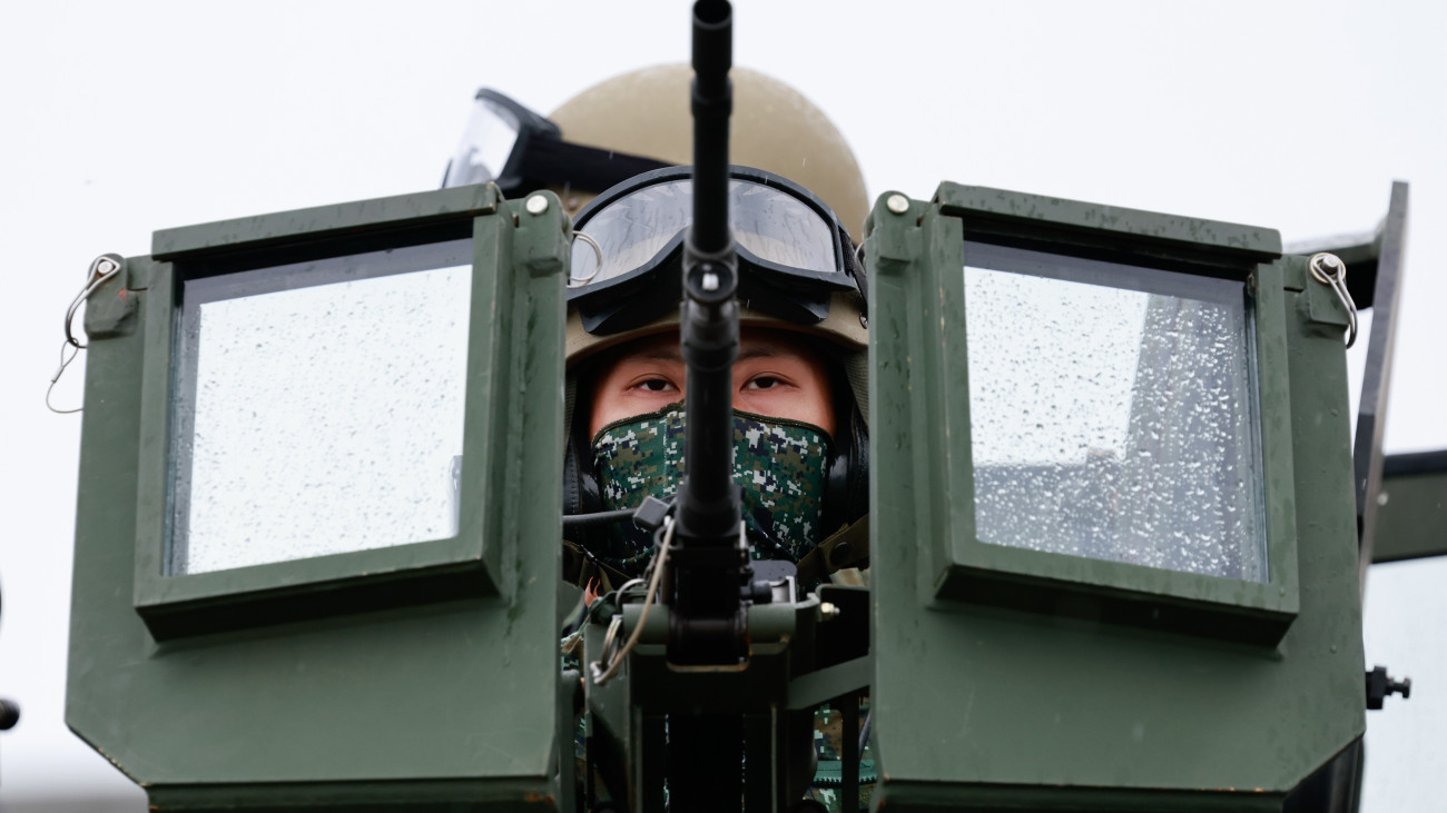 Harckocsizó egy amerikai gyártmányú M1A2T tankon a tajvani hadsereg évenkénti éleslövészati hadgyakorlatán Hszincsu megyében 2025. július 10-én. A tíznapos manőverek célja a kínai inváziós fenyegetéssel szembeni védekezés gyakorlása.