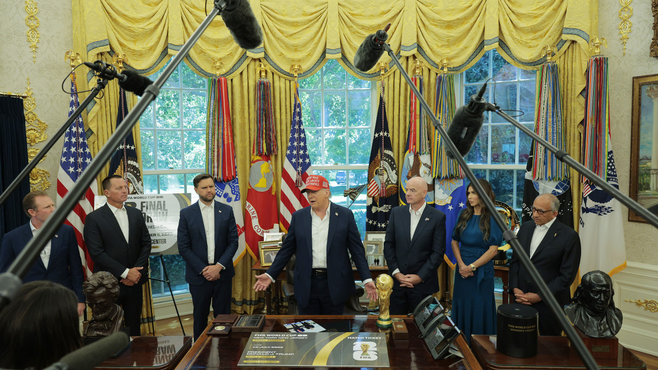 WASHINGTON, DC - AUGUST 22: U.S. President Donald Trump speaks in the Oval Office while Andrew Giuliani (L-R), Richard Grenell, Vice President JD Vance, FIFA President Gianni Infantino (3rd R), Homeland Security Director Kristi Noem, and senior advisor to the White Houseâs World Cup Task Force Carlos Cordeiro look on August 22, 2025 in Washington, DC.  Trump announced the FIFA World Cup 2026 draw will take place at The Kennedy Center.   (Photo by Chip Somodevilla/Getty Images)