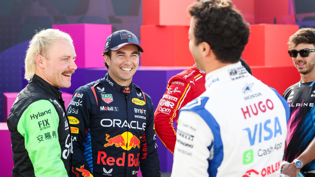 BAHRAIN, BAHRAIN - FEBRUARY 21: Valtteri Bottas of Finland and Stake F1 Team Kick Sauber Sergio Perez of Mexico and Oracle Red Bull Racing and Daniel Ricciardo of Australia and Visa Cash App RB talk prior to F1 Testing at Bahrain International Circuit on February 21, 2024 in Bahrain, Bahrain. (Photo by Peter Fox - Formula 1/Formula 1 via Getty Images)