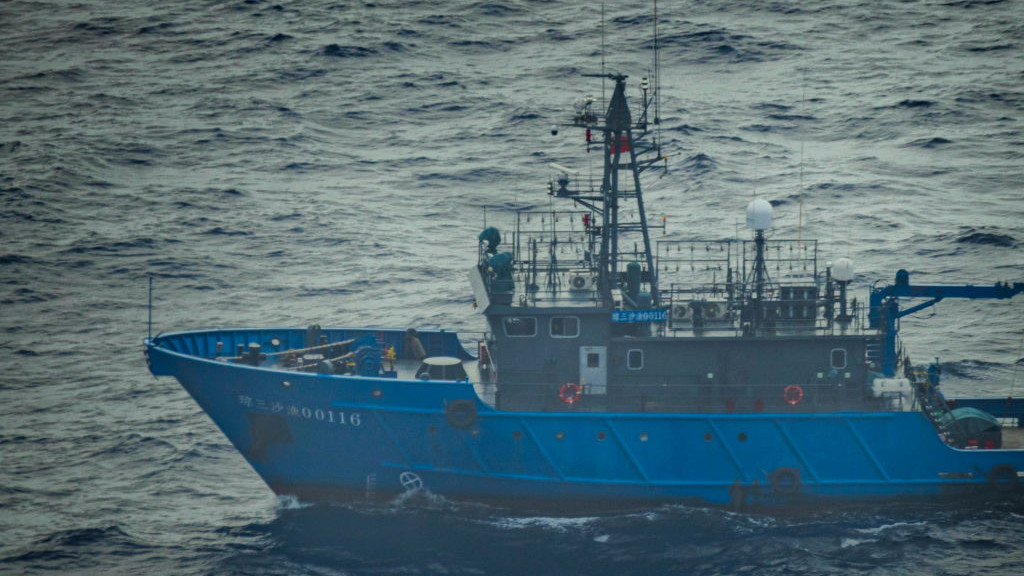 SCARBOROUGH SHOAL, SOUTH CHINA SEA - FEBRUARY 18: A Chinese maritime militia ship sails near the waters of Scarborough Shoal, as seen from aboard a Philippine Bureau of Fisheries and Aquatic Resources plane on February 18, 2025 in the South China Sea. A Chinese Navy helicopter nearly collided with a Philippine Bureau of Fisheries and Aquatic Resources plane in the latest flare-up of tensions between the two countries in the disputed waters. The incident occurred when the Chinese Navy deployed a helicopter to tail the Philippine civilian plane, which was conducting a routine maritime domain awareness flight over Scarborough Shoal, located within the Philippines exclusive economic zone. (Photo by Ezra Acayan/Getty Images)