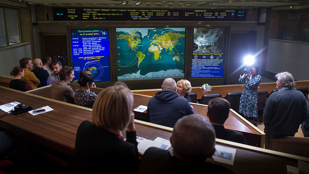 KOROLOV, RUSSIA - OCTOBER 21: In this handout provided by NASA, friends and family members of the Soyuz MS-02 crew watch a live view of the International Space Station, as seen by cameras onboard the spacecraft with Expedition 49-50 crewmembers Shane Kimbrough of NASA, Sergey Ryzhikov of Roscosmos, and Andrey Borisenko of Roscosmos onboard, on screens at Moscow Mission Control Center as the spacecraft approaches for docking, Friday, Oct. 21, 2016 in Korolov, Russia.  The Soyuz MS-02 spacecraft carrying Kimbrough, Ryzhikov, and Borisenko docked at 5:52 a.m. EDT Friday, Oct. 21, 251 statute miles over southern Russia and joined Expedition 49 Commander Anatoly Ivanishin of Roscosmos and flight engineers Kate Rubins of NASA and Takuya Onishi of the Japan Aerospace Exploration Agency (JAXA). (Photo by Joel Kowsky/NASA via Getty Images)