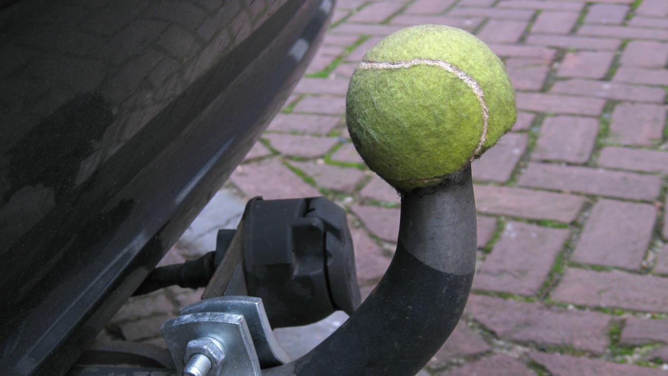 Simple idea to recycle a tennis ball to protect a car hook close up