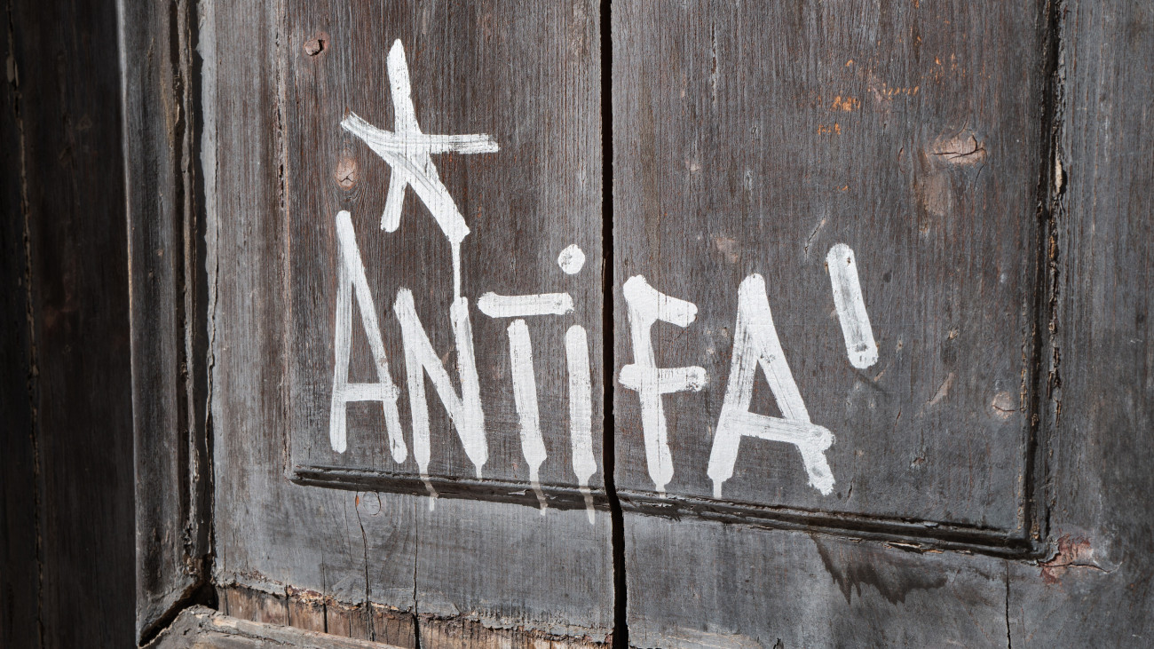 A close-up of graffiti reading Antifa is painted in white on the wooden door of a university building  in Bari, Italy, on September 19, 2025. (Photo by Matteo Della Torre/NurPhoto via Getty Images)