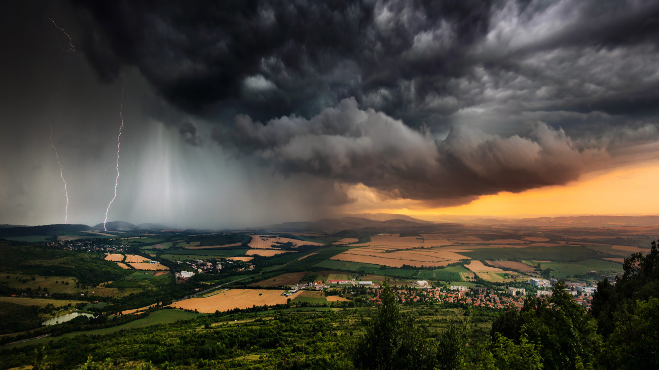 A severe thunderstorm shelf cloud races across the country side on a summer afternoon
