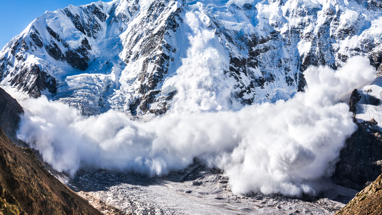 Power of nature. Real huge avalanche comes from a big mountain (Shkhara, 5,193 m), Caucasus, Kabardino-Balkaria, Bezengi region, Russia