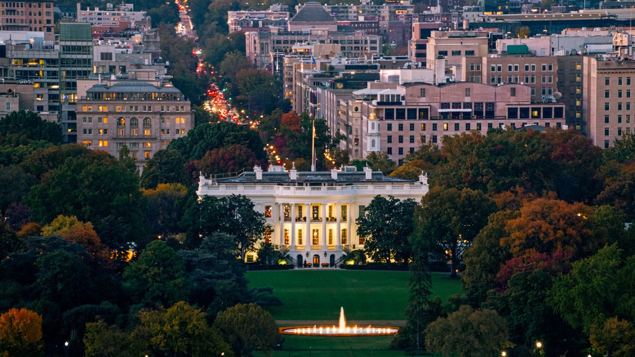 Helicopter shot of the White House in Washington, D.C. at dusk on a clear evening in Fall.