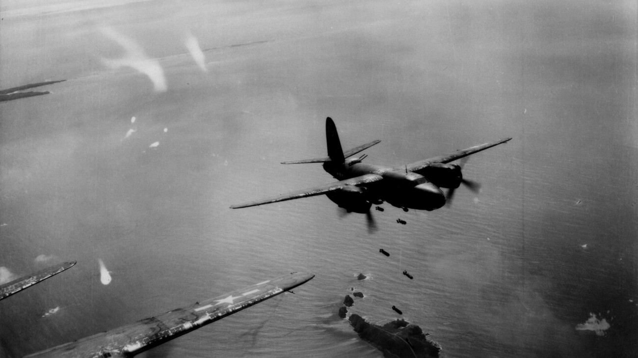 FRANCE - SEPTEMBER 1944:  A Douglas A-26 Invader from the United States Air Force 9th Airborne Division drops bombs on the coast of France as seen from another plane in the squadron in September 1944 in France. (Photo by Edward Mansfield/Michael Ochs Archives/Getty Images)