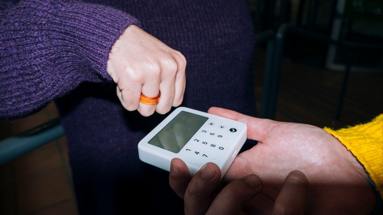 Shopper using contactless payment ring technology on pos terminal for a secure and convenient transaction