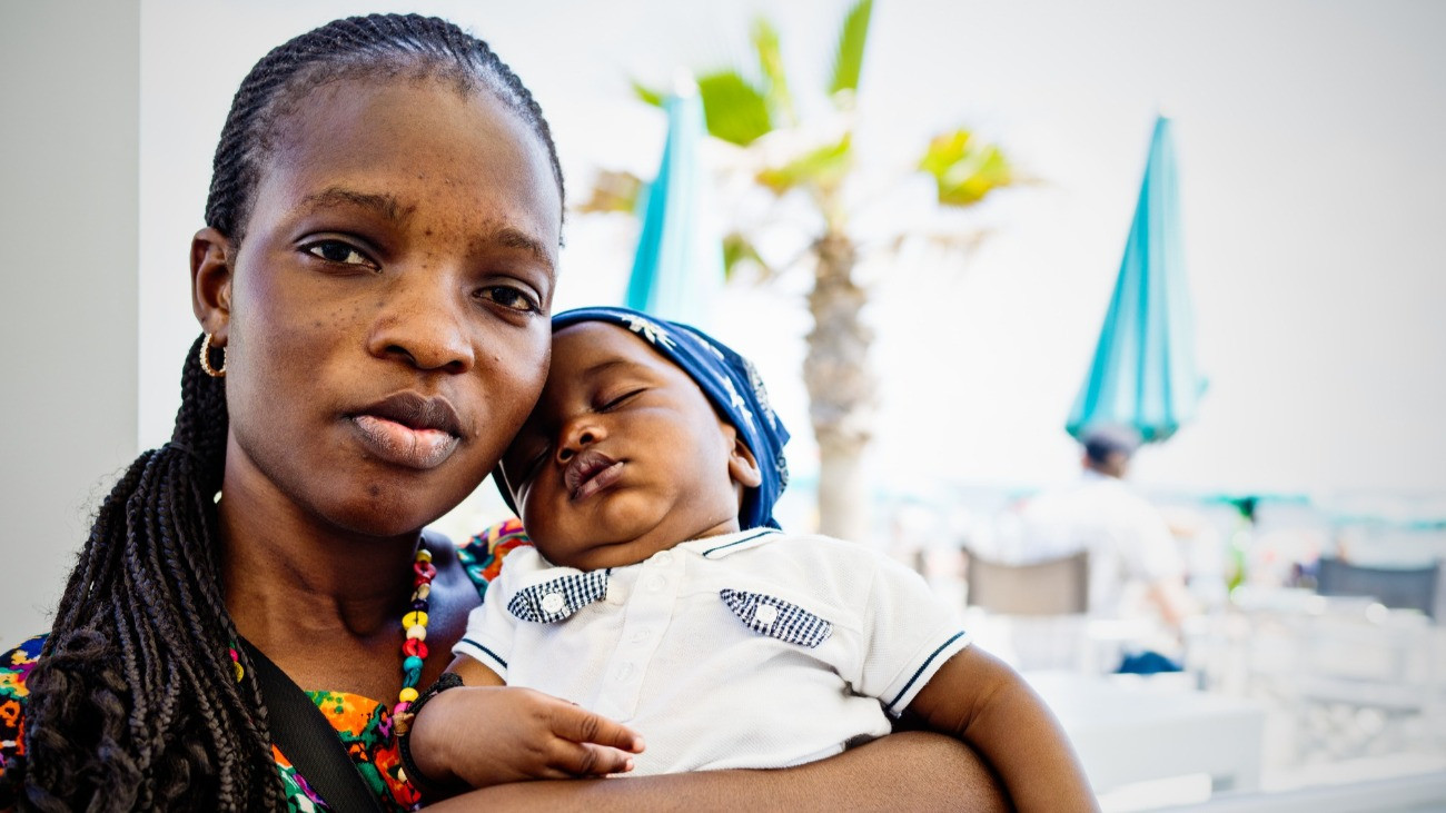 Young African emigrant mother with baby