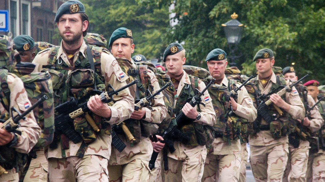 The Hague, Holland - June 25, 2011: Soldiers with guns marching past on Veterans Day parade in The Hague, Holland on June 25, 2011