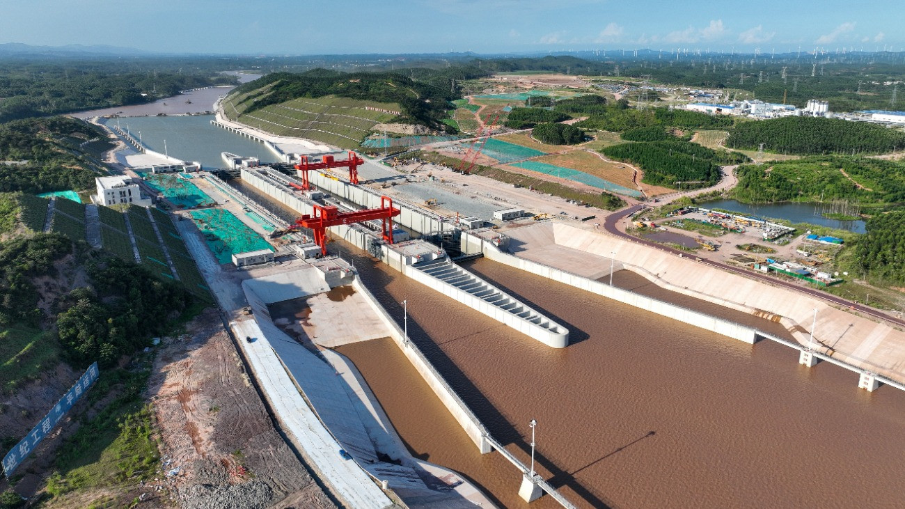 QINZHOU, CHINA - JUNE 03: An aerial view shows the Qingnian Hub undergoing water debugging as part of the Pinglu Canal project on June 3, 2026 in Qinzhou, Guangxi Zhuang Autonomous Region of China. A site promotion meeting marked the 100-day countdown to the canals navigation. The Pinglu Canal is a backbone project of the New International Land-Sea Trade Corridor in western China, with main construction largely completed and operational preparations underway for a targeted opening in September. (Photo by Chen Guanyan/China News Service/VCG via Getty Images)