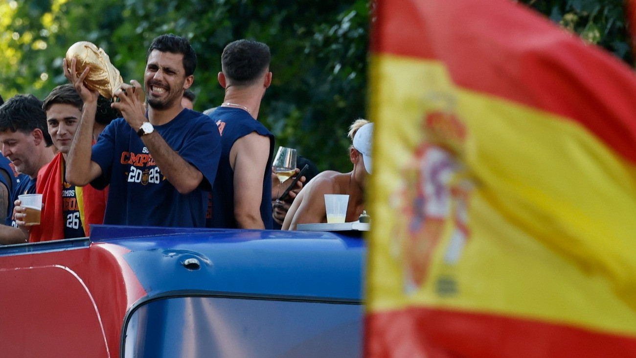 A csapatkapitány Rodri fogja a trófeát, amint a világbajnok spanyol labdarúgó-válogatott nyitott tetejû autóbuszon diadalmenetben hajtat végig Madrid utcáin 2026. július 20-án. Spanyolország az elõzõ nap hosszabbításban 1-0-ra gyõzött Argentína ellen a 2026-os labdarúgó-világbajnokság döntõjében.